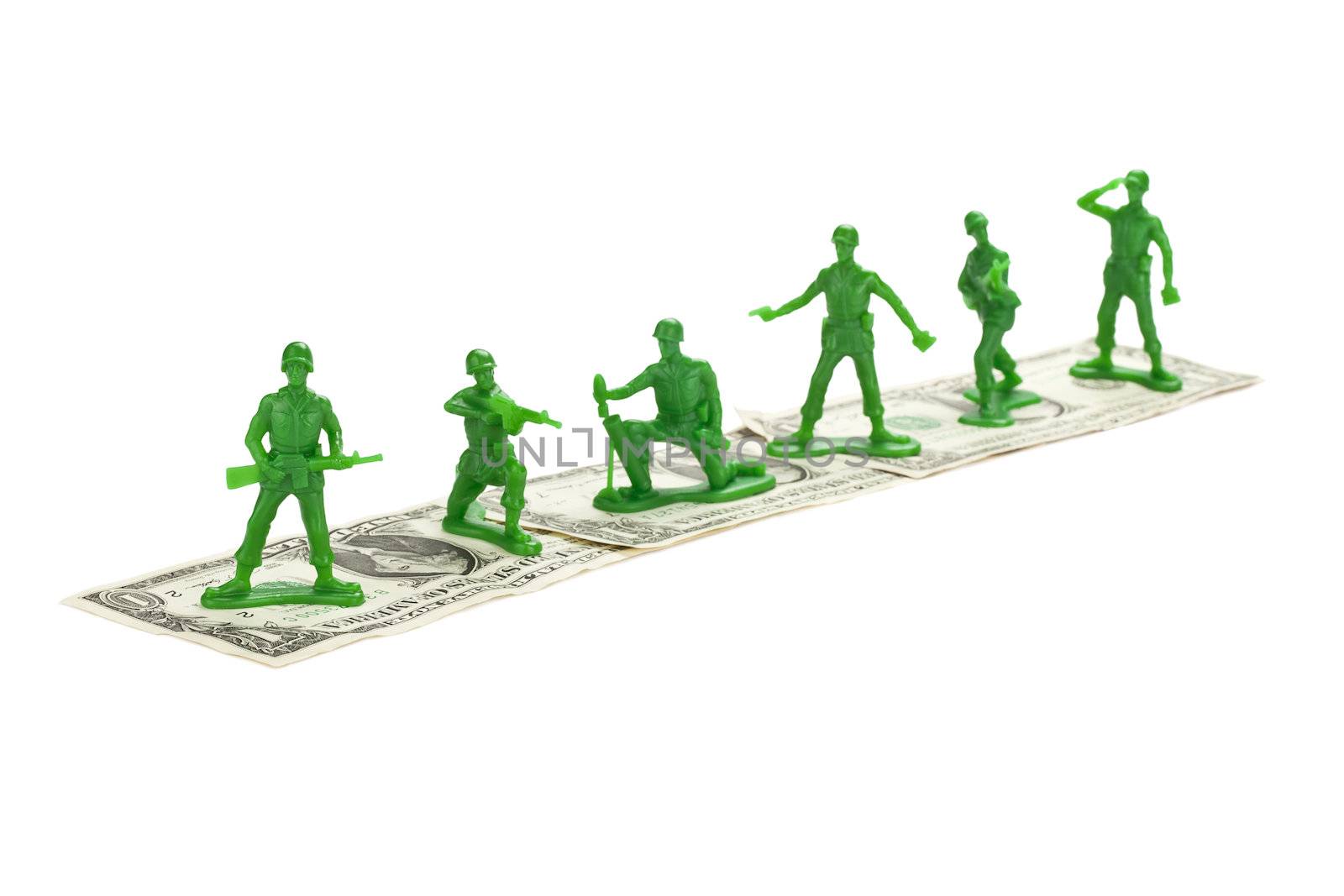 Toy Soldiers standing on a dollar isolated on 