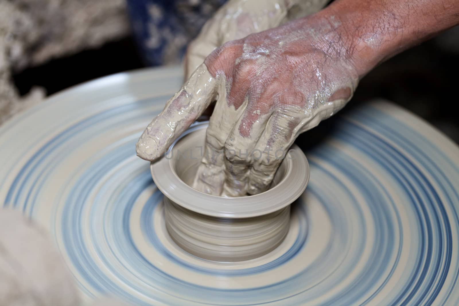 hands on a piece of pottery made of clay  by jame_j@homail.com