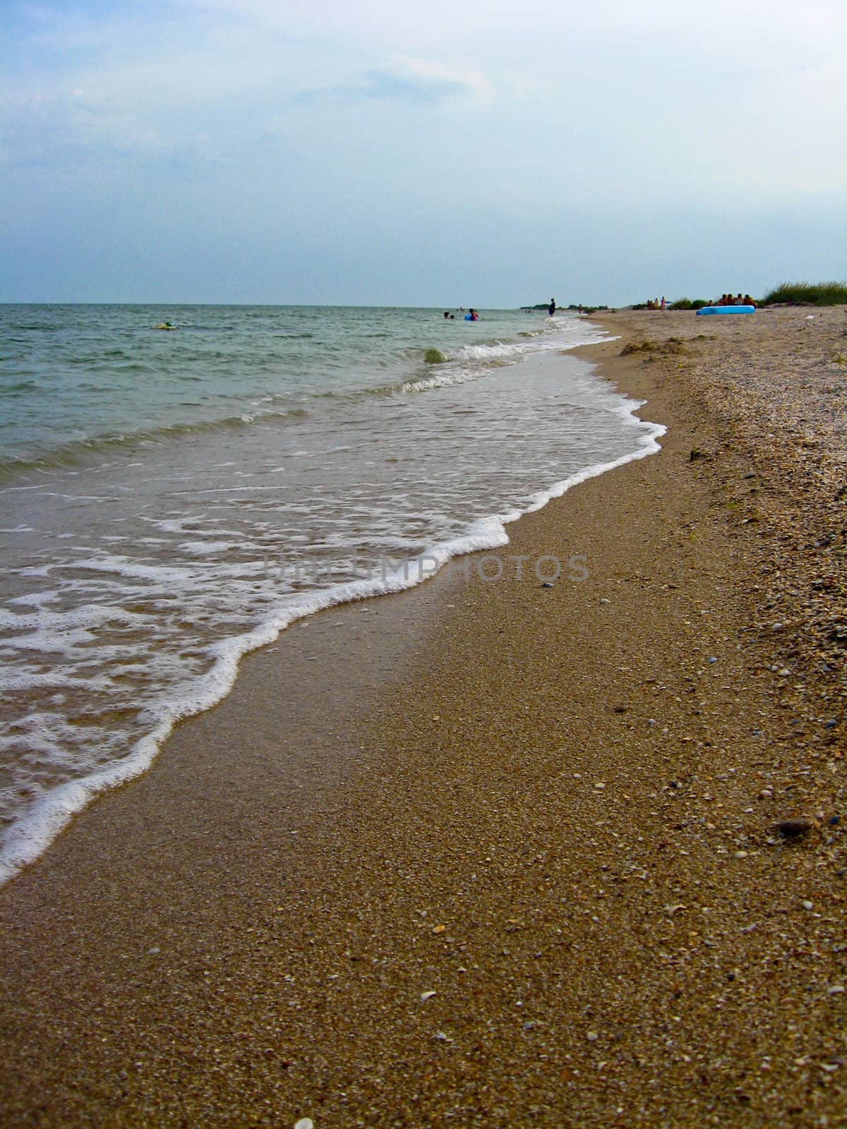 Marine waves on the sand of seacoast