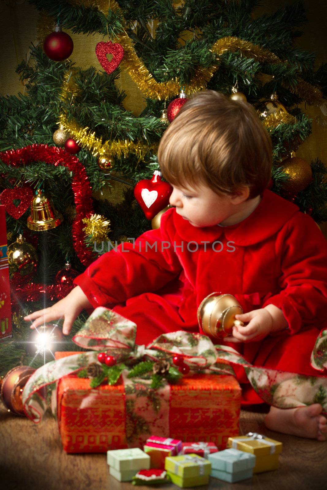 baby play with present box at Christmas tree