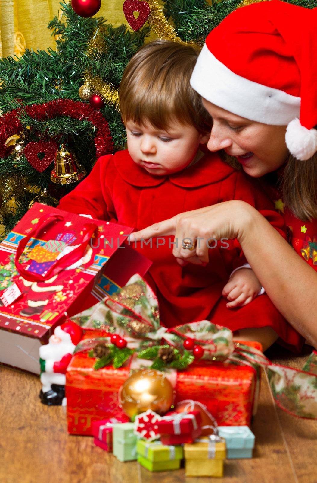 Young mother with  baby  at Christmas tree