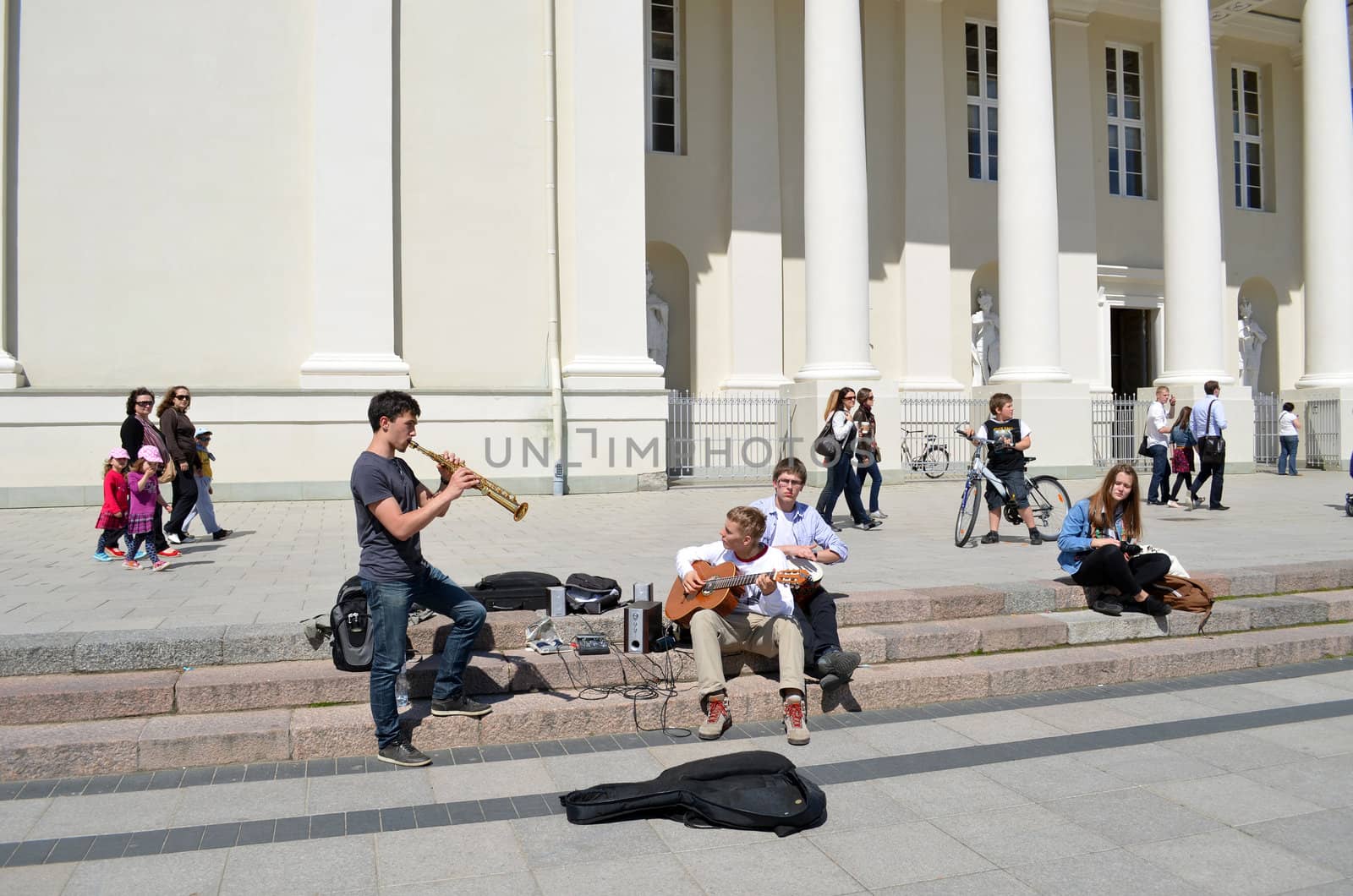 VILNIUS, LITHUANIA - MAY 19: Young unidentified students play pipe and guitar on pavement near Cathedral on May 19, 2012 in Vilnius. Street Music Day.