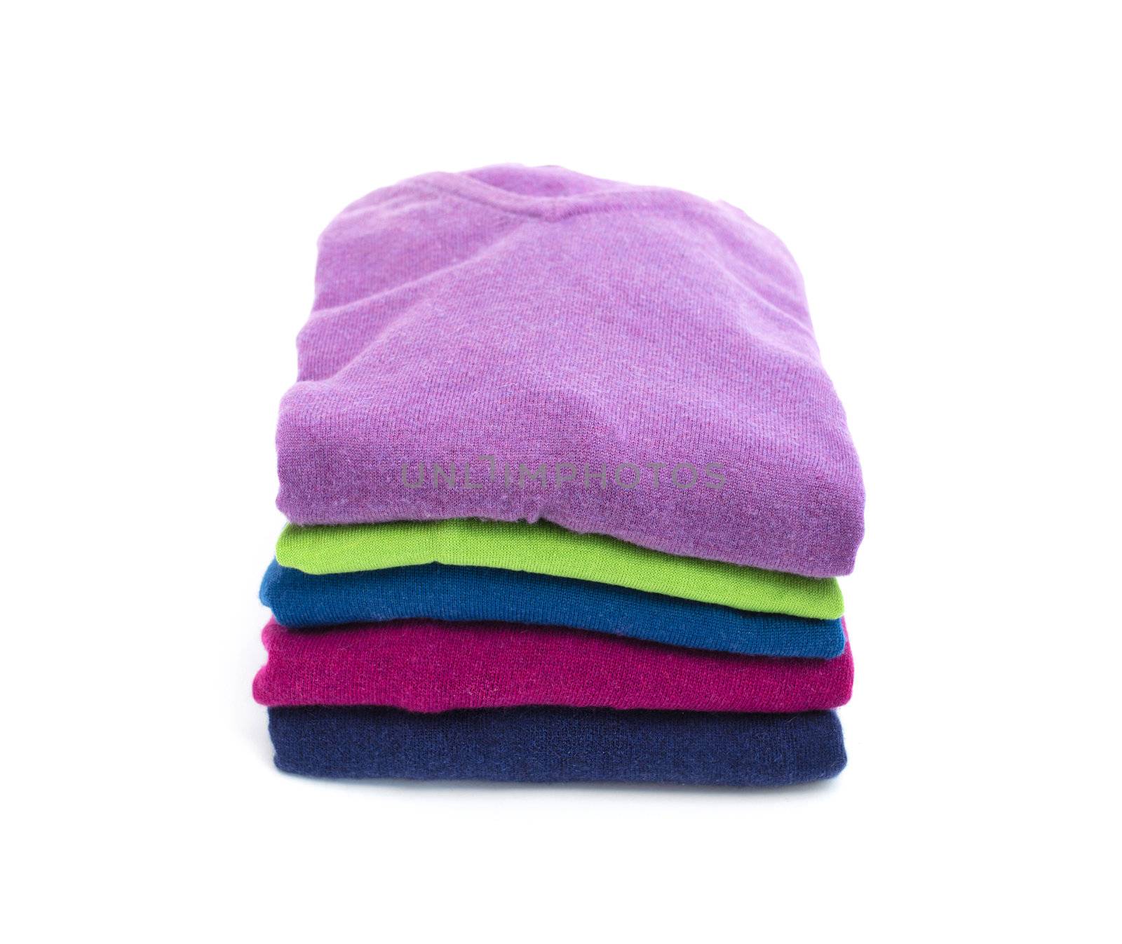 Stack of colorful wool sweaters by artofphoto