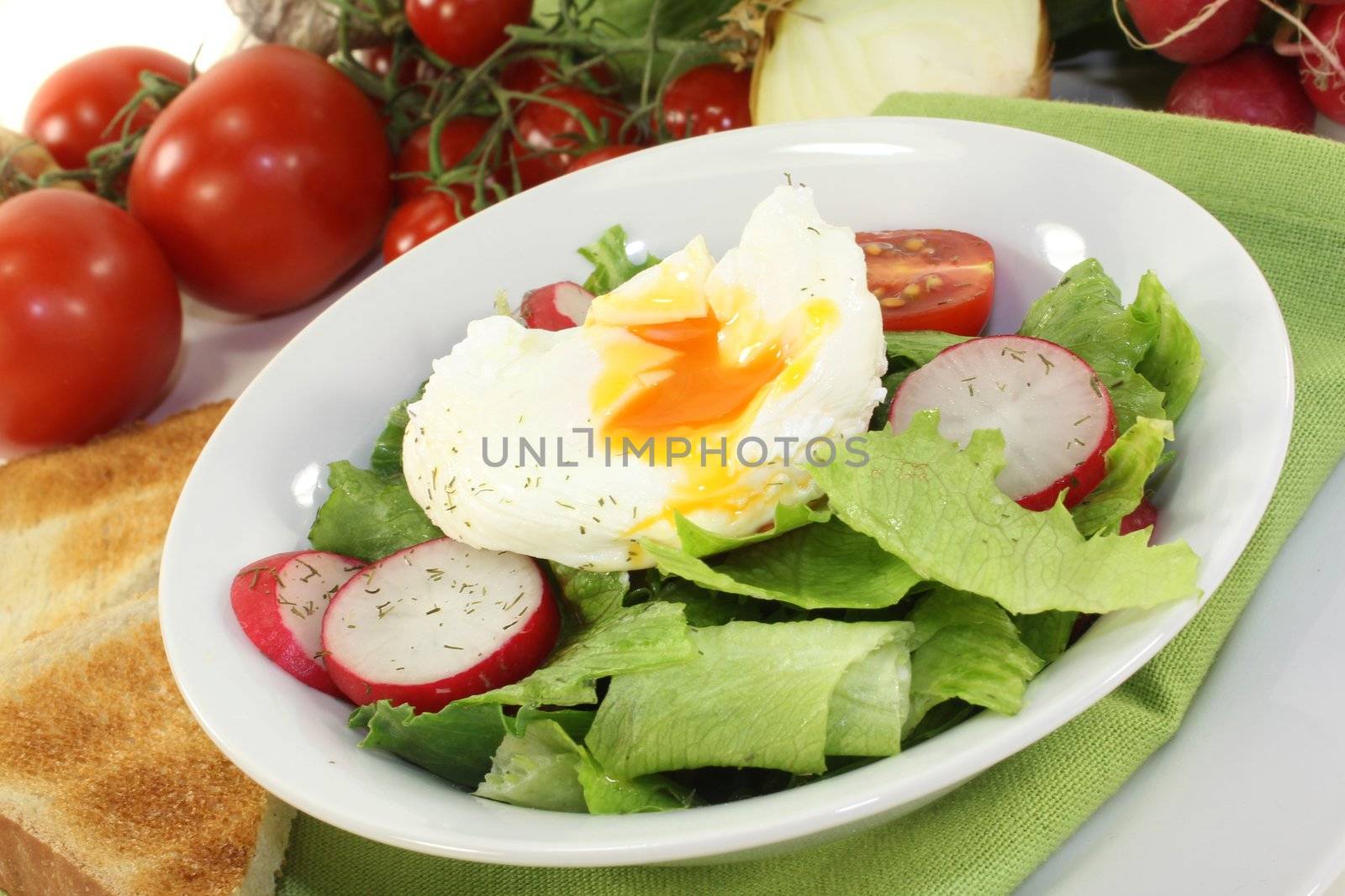 colorful mixed salad with poached egg