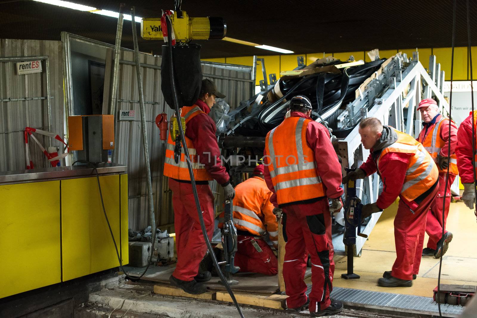 STUTTGART - OCTOBER 24: Workers are installing a new escalator during renovation works in the metropolitan railway station Schwabstraße using heavy machinery in the late evening of October 24, 2012 in Stuttgart, Germany