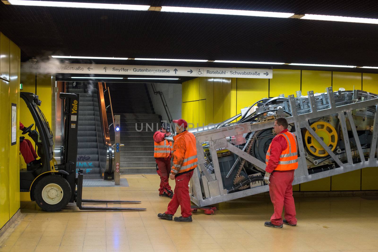 STUTTGART - OCTOBER 24: Workers are installing a new escalator during renovation works in the metropolitan railway station Schwabstraße using a forklift in the late evening of October 24, 2012 in Stuttgart, Germany