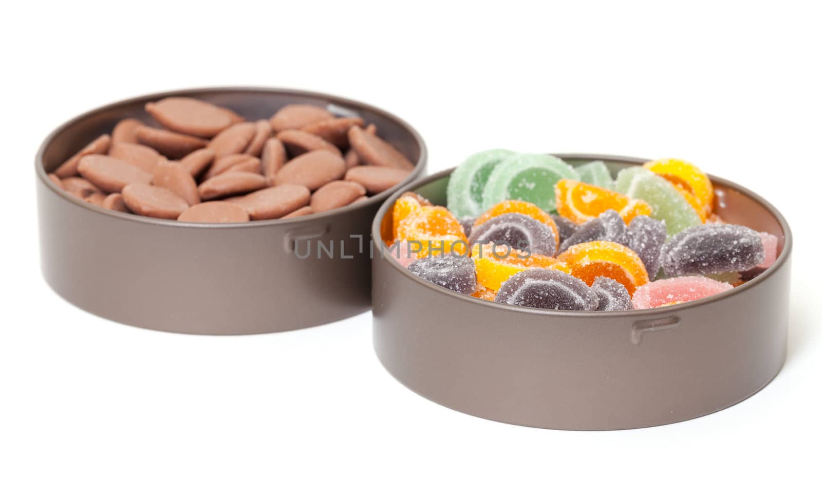 Colorful Jelly and Chocolate Candies in tin cans, on white background