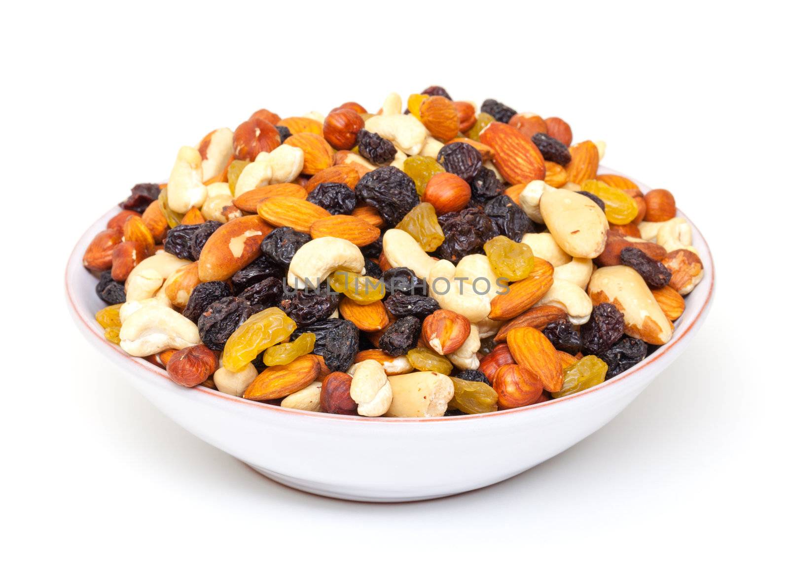 Mixture of nuts and raisins in bowl, on white background