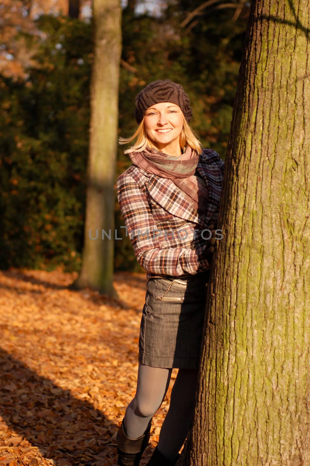 Young woman enjoying sunny day in autumn in the park