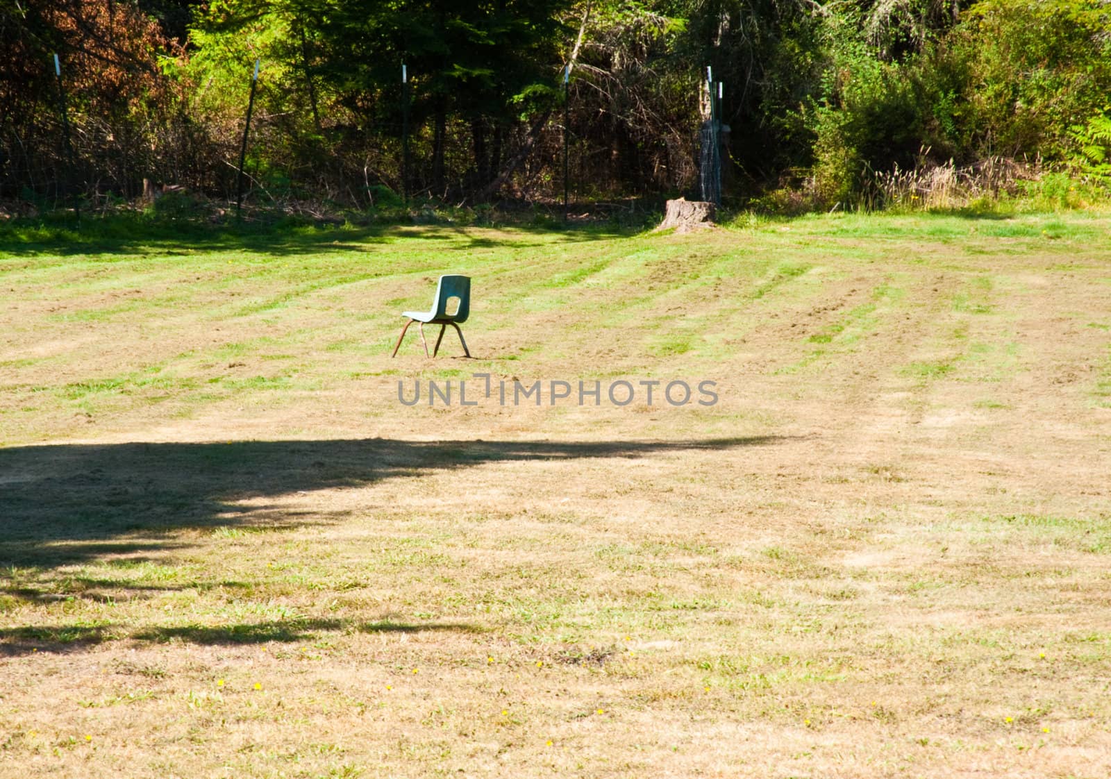 Empty child’s chair in a field