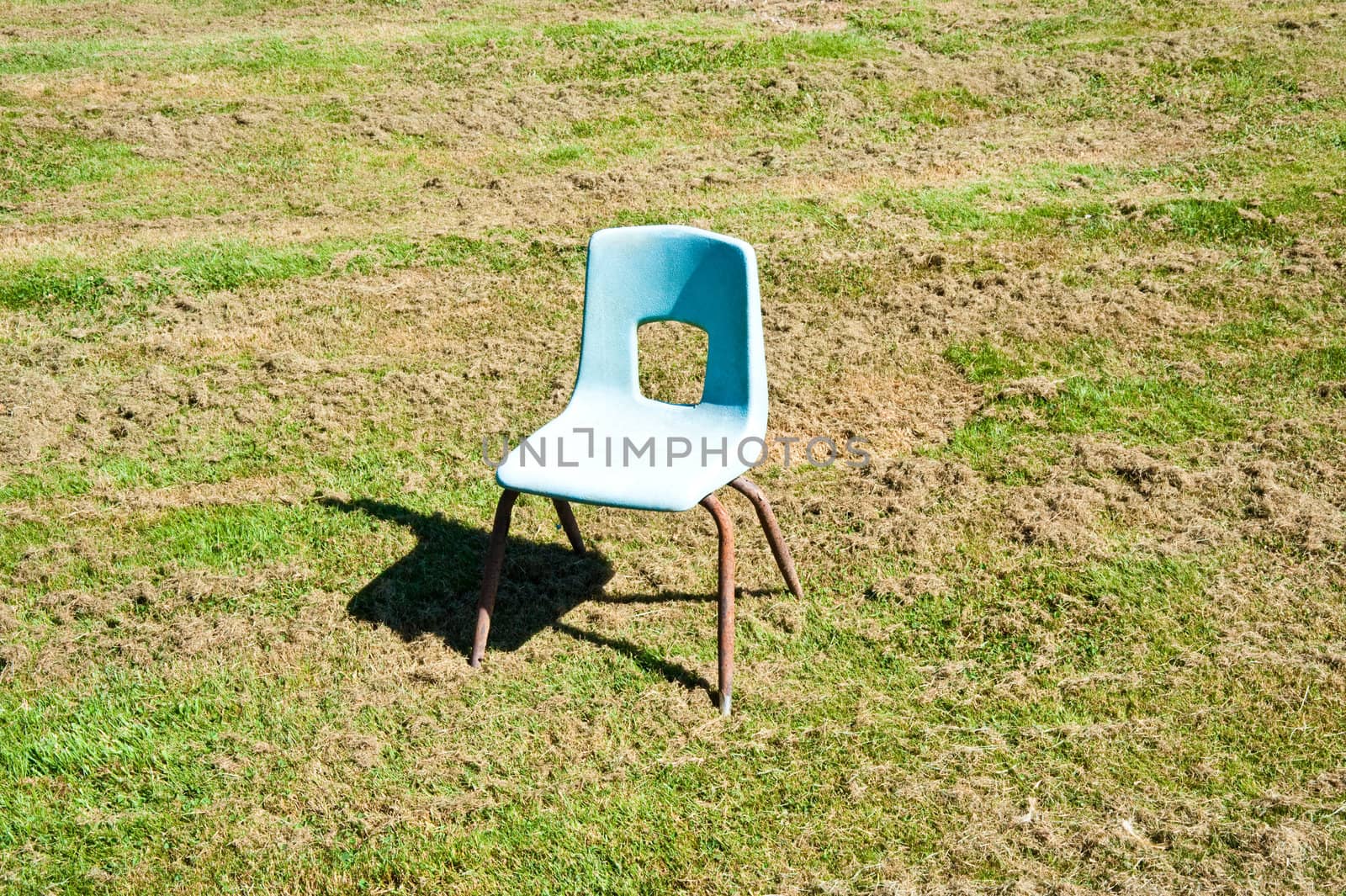 Empty child’s chair in a field