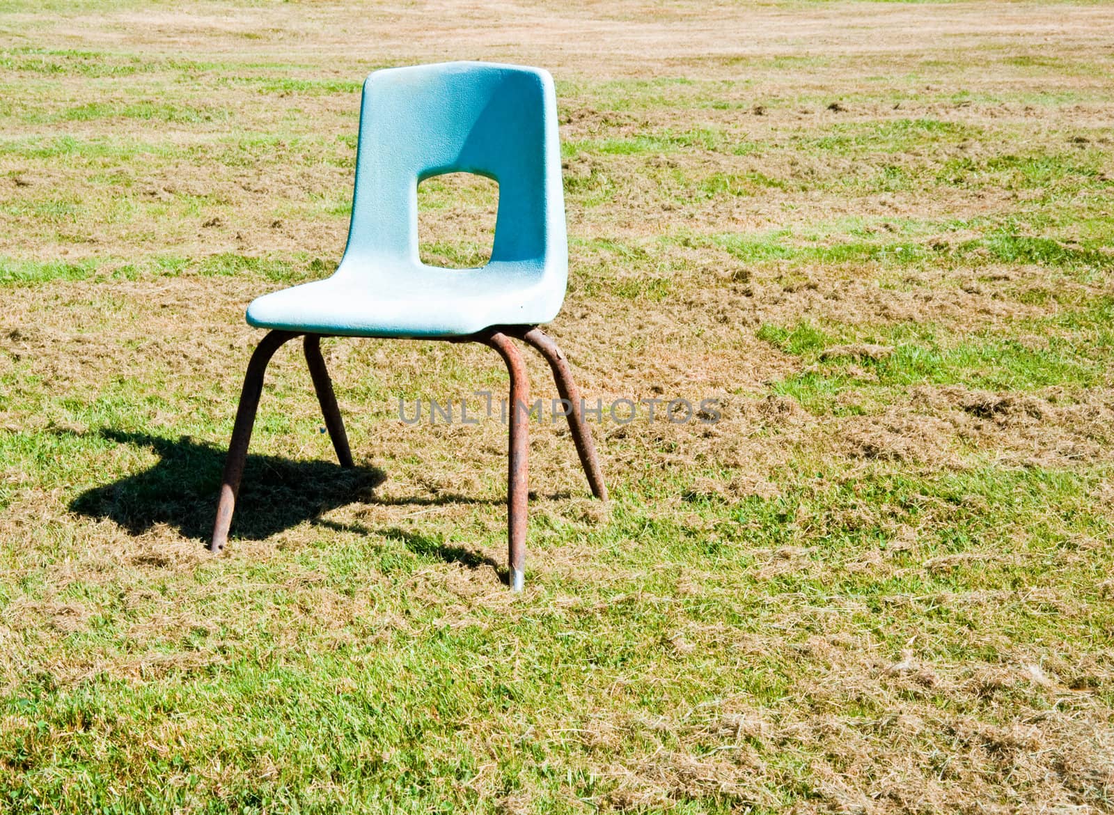 Empty child’s chair in a field