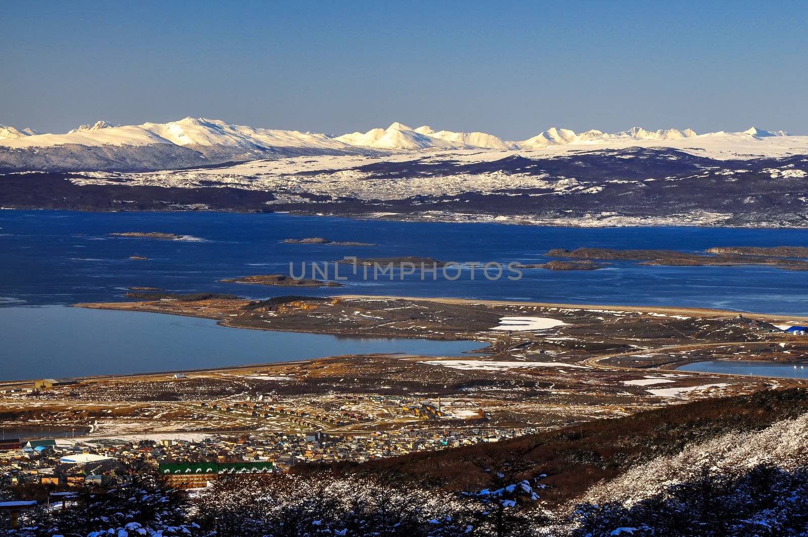 Ushuaia with the Beagle Channel and snow covered mountains behind it.