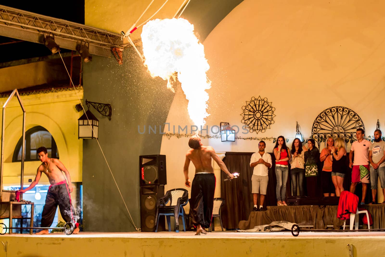 Spectacular show at an outdoor stage in Hammamet, Tunisia, where Local talent showcase their extraordinary ability to breathe fire like the mystical fire breathing dragons.