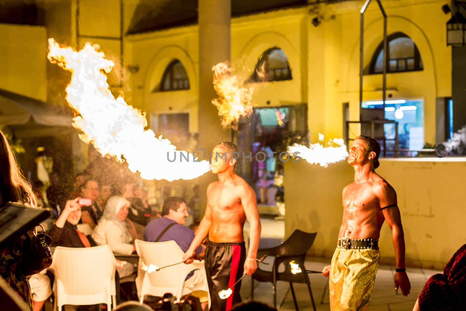 Spectacular show at an outdoor stage in Hammamet, Tunisia, where Local talent showcase their extraordinary ability to breathe fire like the mystical fire breathing dragons.