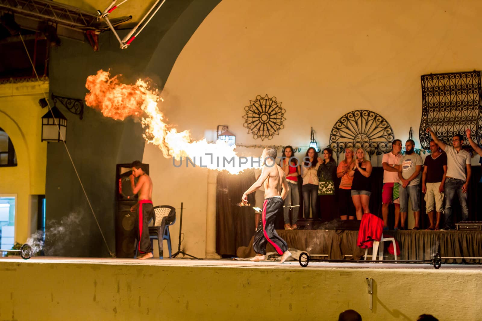 Spectacular show at an outdoor stage in Hammamet, Tunisia, where Local talent showcase their extraordinary ability to breathe fire like the mystical fire breathing dragons.