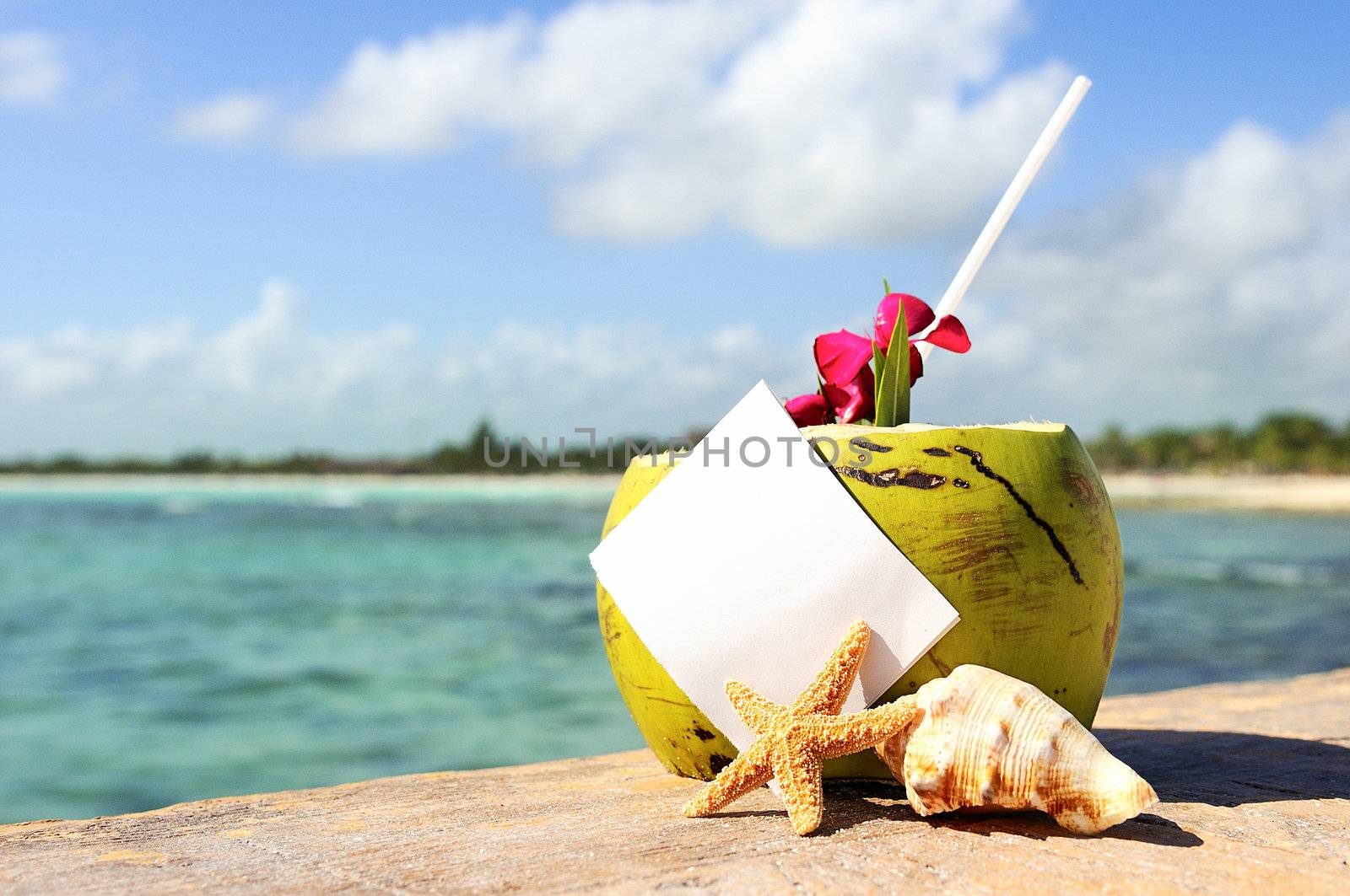 Coconut cocktail starfish tropical Caribbean beach refreshment and towel