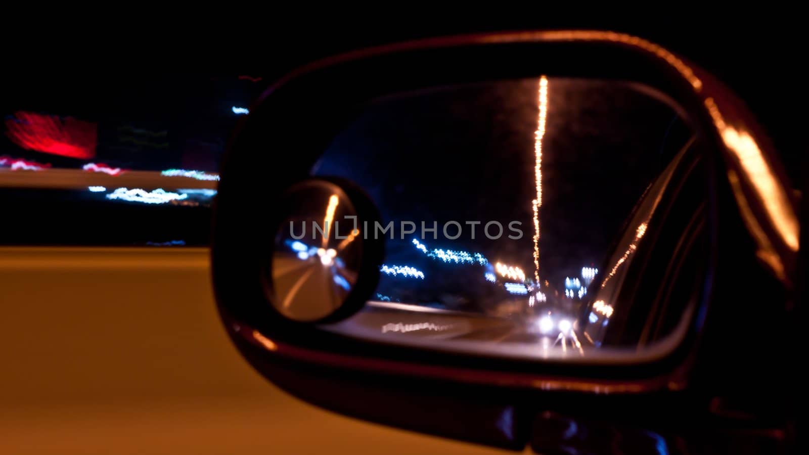 Night traffic shoot from the window of rush car motion blur steet light.