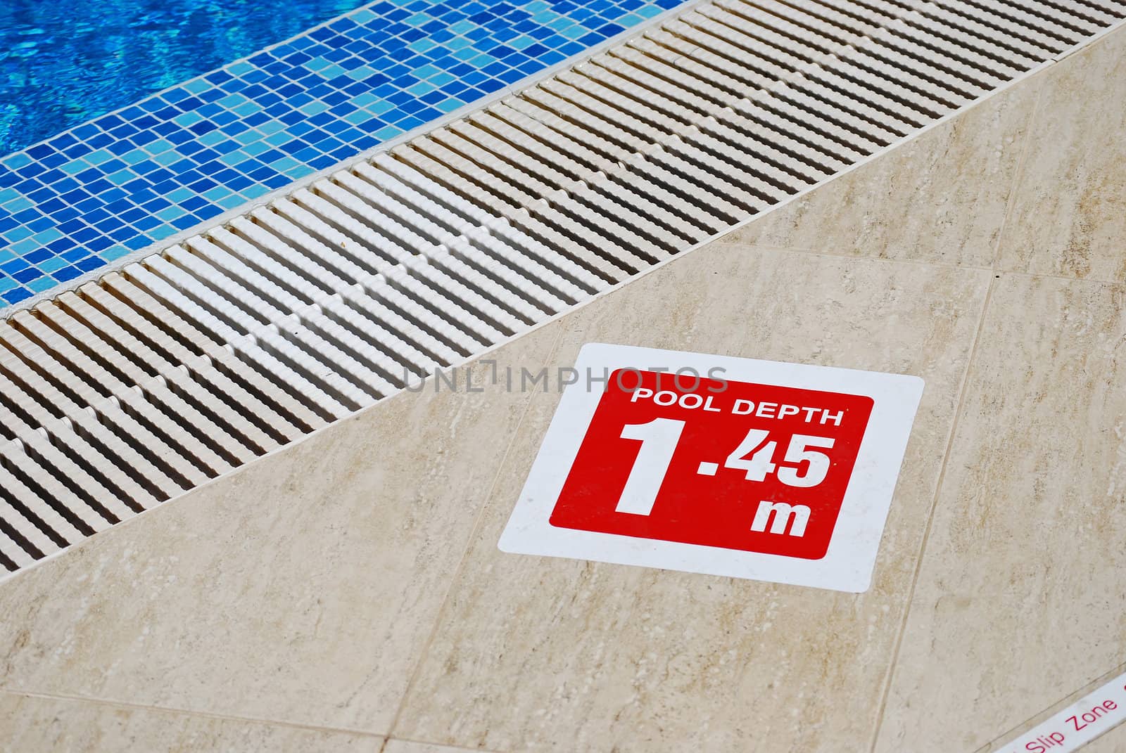 Red pool depth sign, water, overflow drain