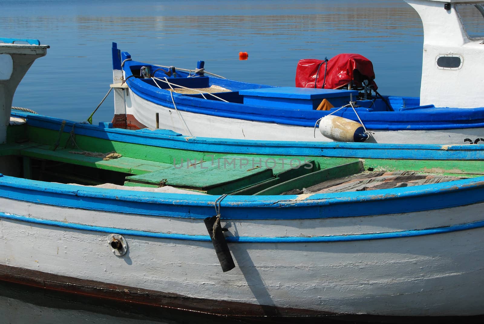 Blue and white fish boats on water