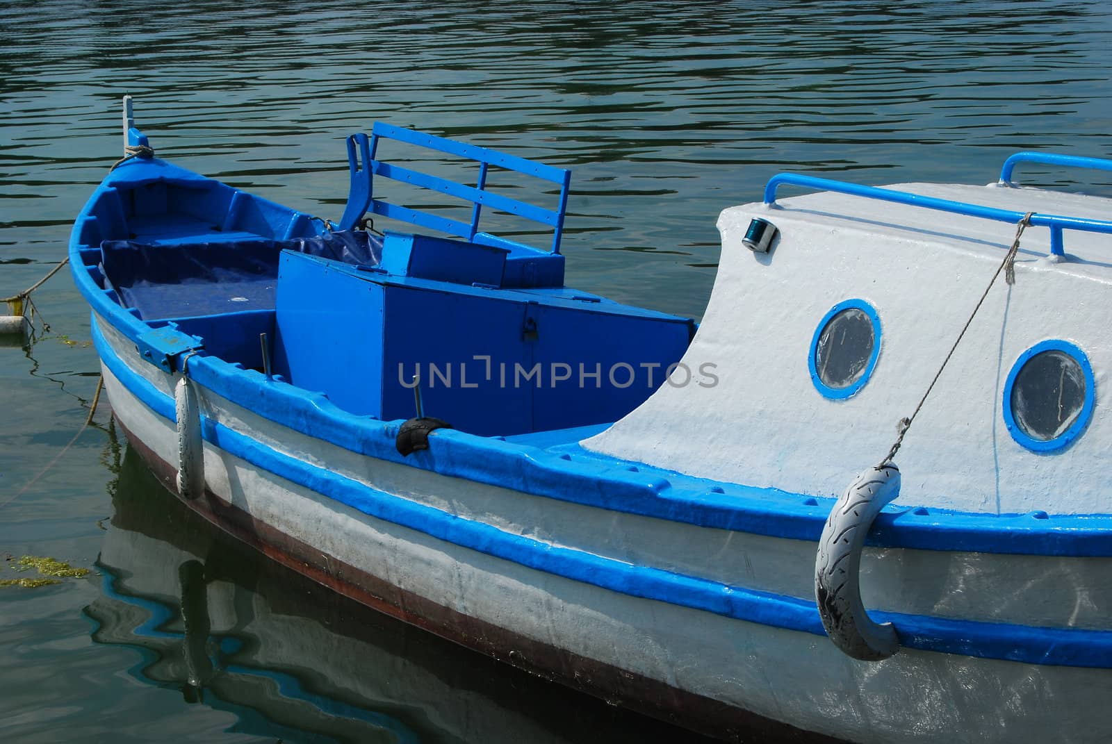 Little blue and white sea boat on water