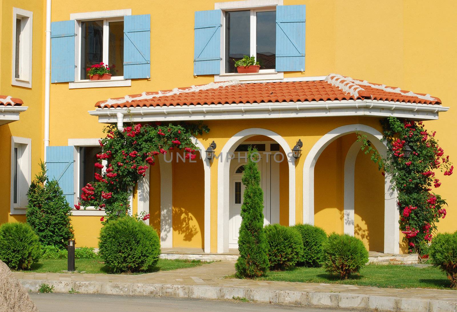 Orange country house back door, blue shutters