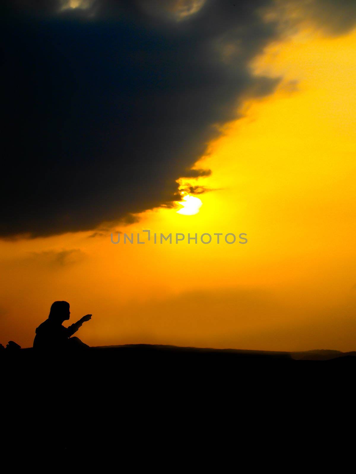Sitting man in sunrise by gjeerawut