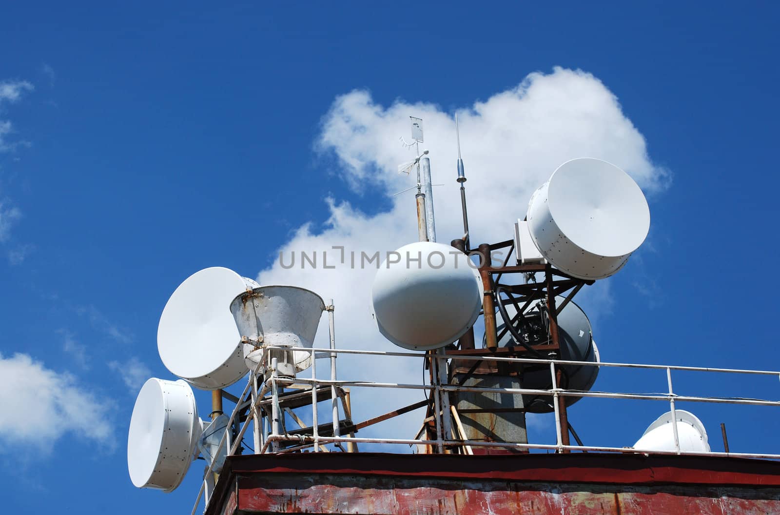 Mountain peak antennas and communication equipment on blue-sky background