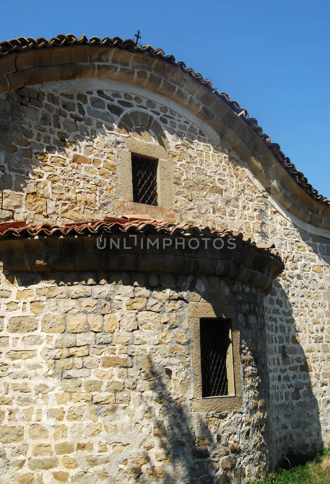 Old orthodox small village stone church, back side