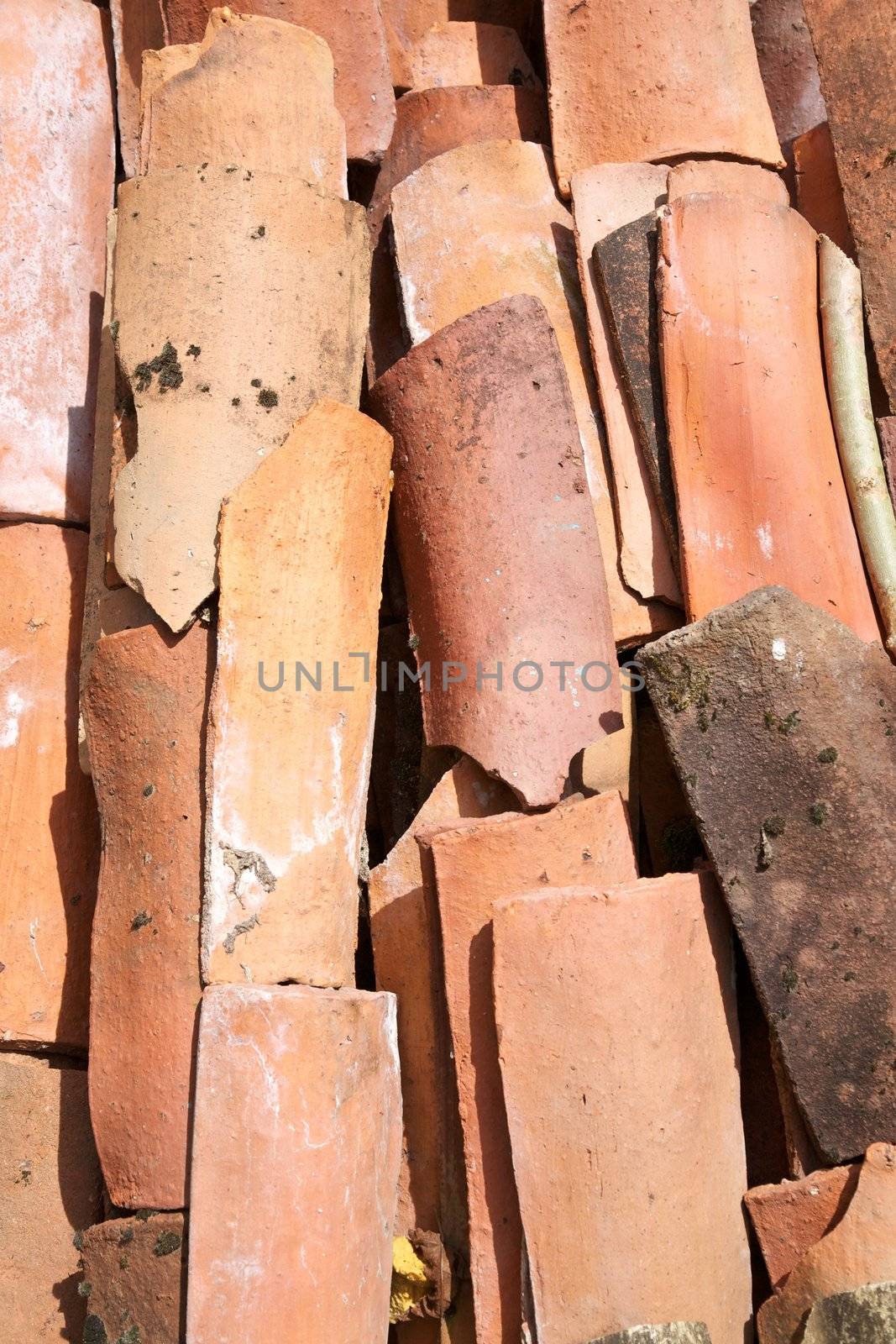big group of orange tiles stacked on a great pile