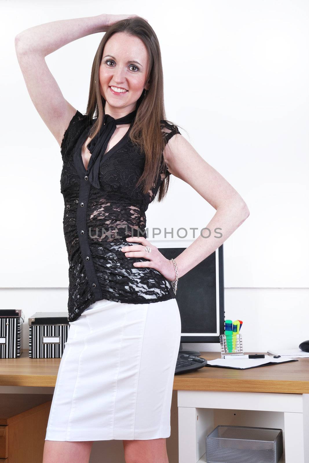 Secretary posing at desk
