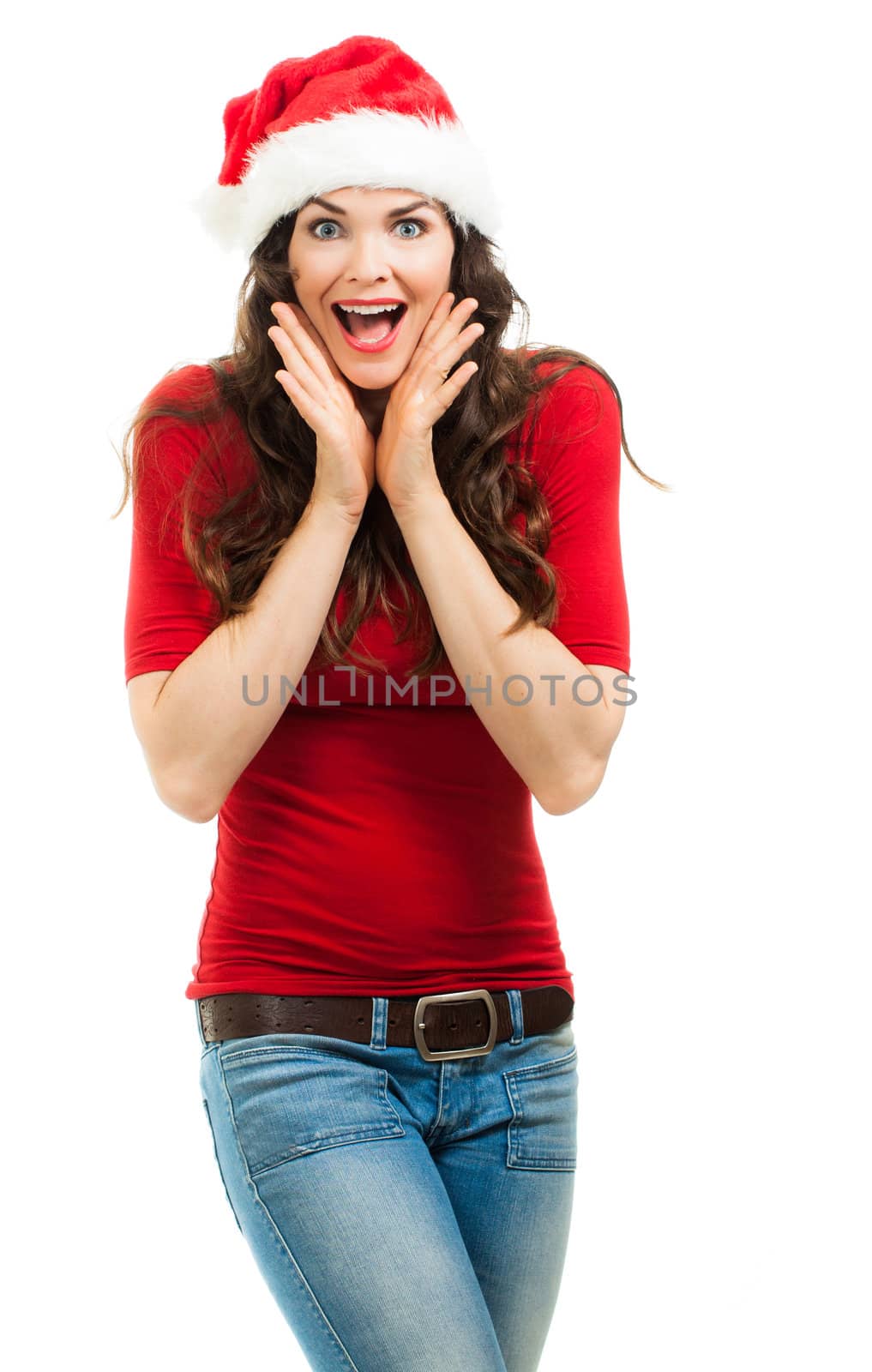A beautiful happy surprised woman dressed in a red top and Santa hat. Isolated on white.