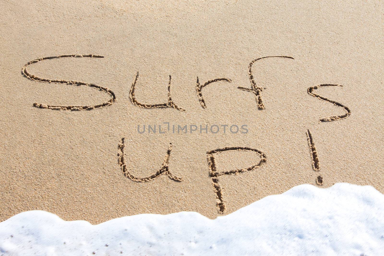 Surf's up - written in the sand with a foamy wave underneath
