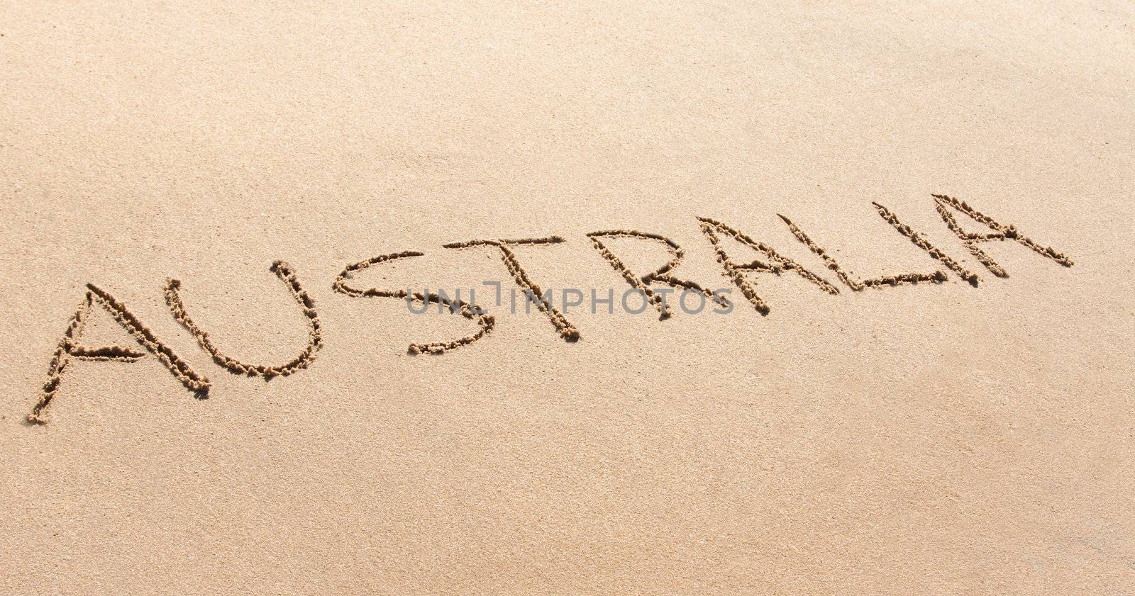 Australia written in the sand on a beach by Jaykayl