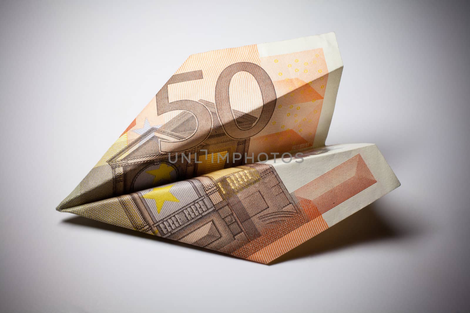 Paper airplane model made of money by Portokalis