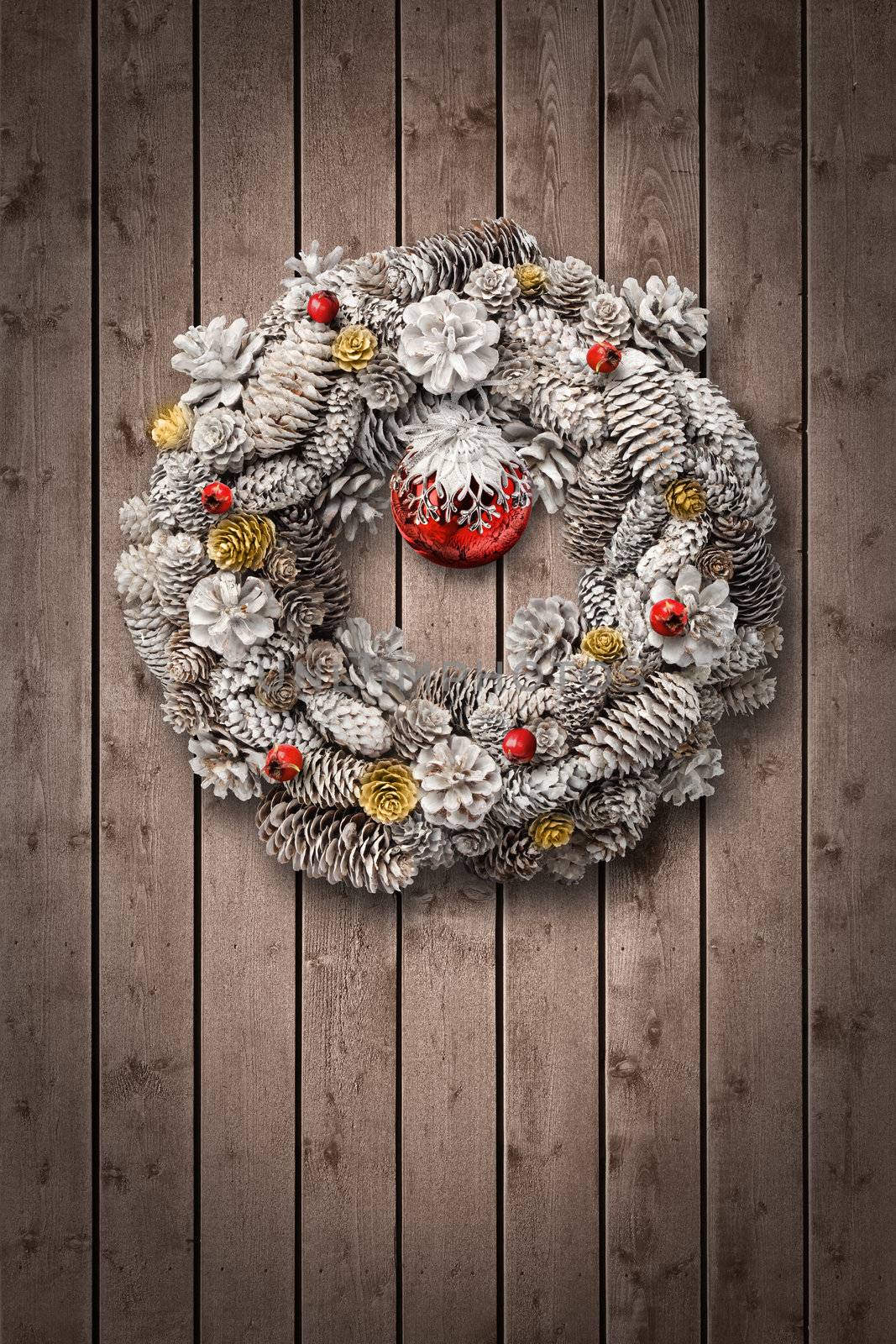 White Christmas wreath on wooden door by anterovium