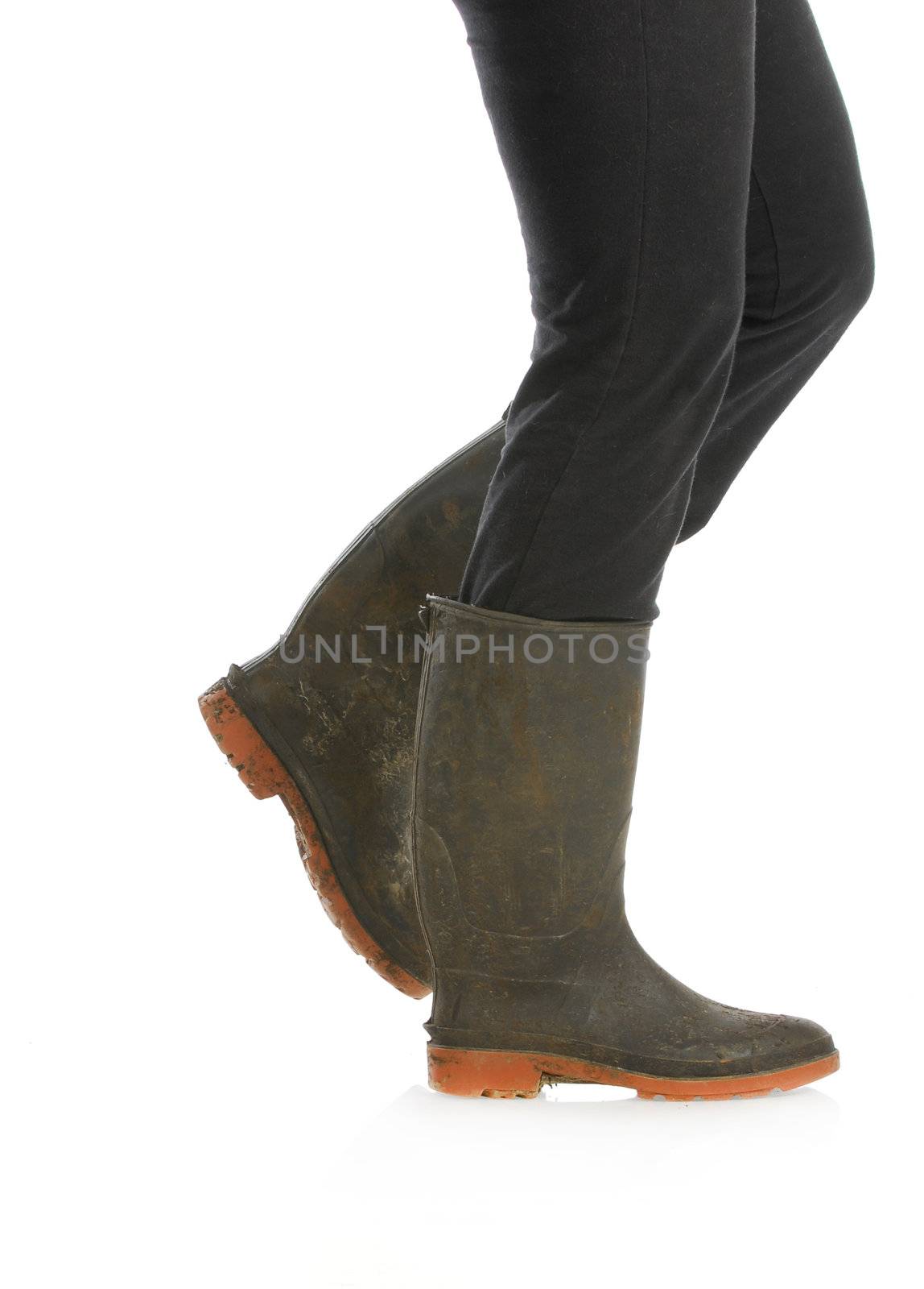 muddy boots - woman walking with muddy boots on white background