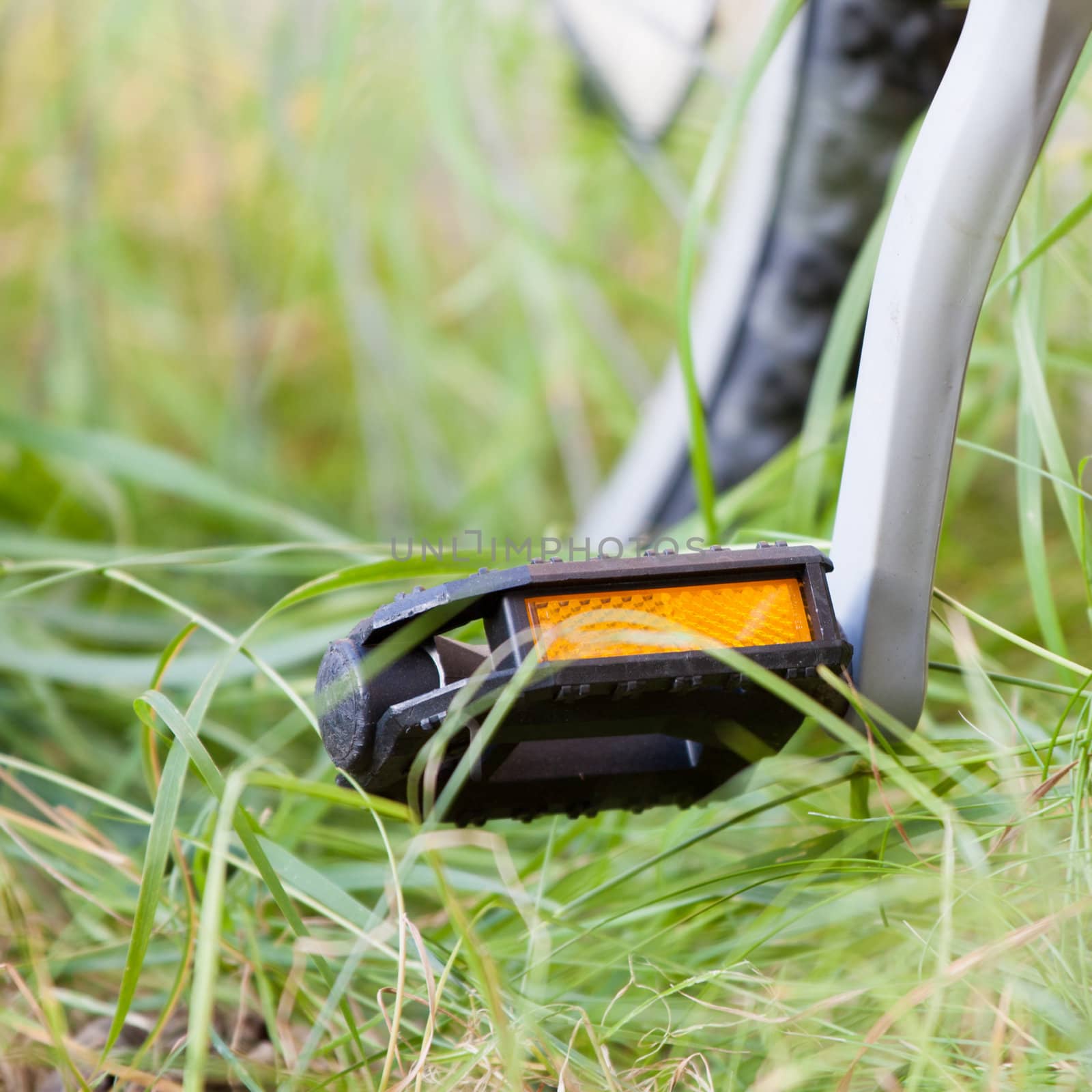 Closeup of a pedal of a bicycle outdoors.