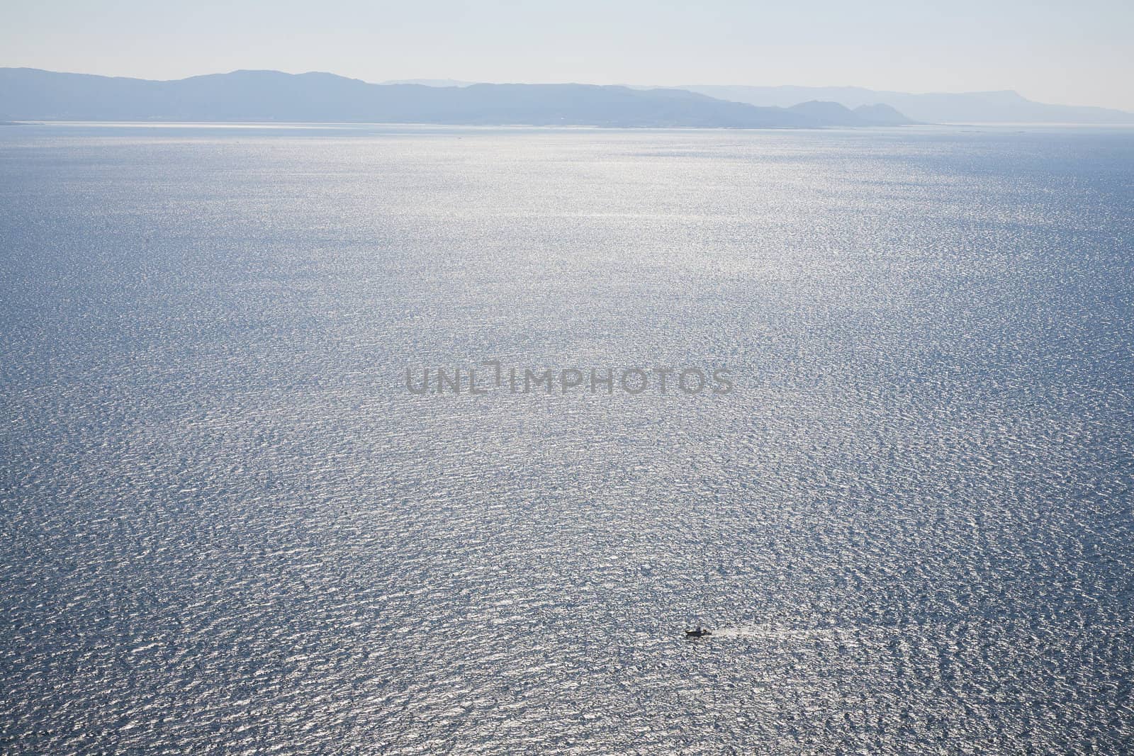 Small fishing boat in morning light outside the the Spanish west coast on the Atlantic Ocean.