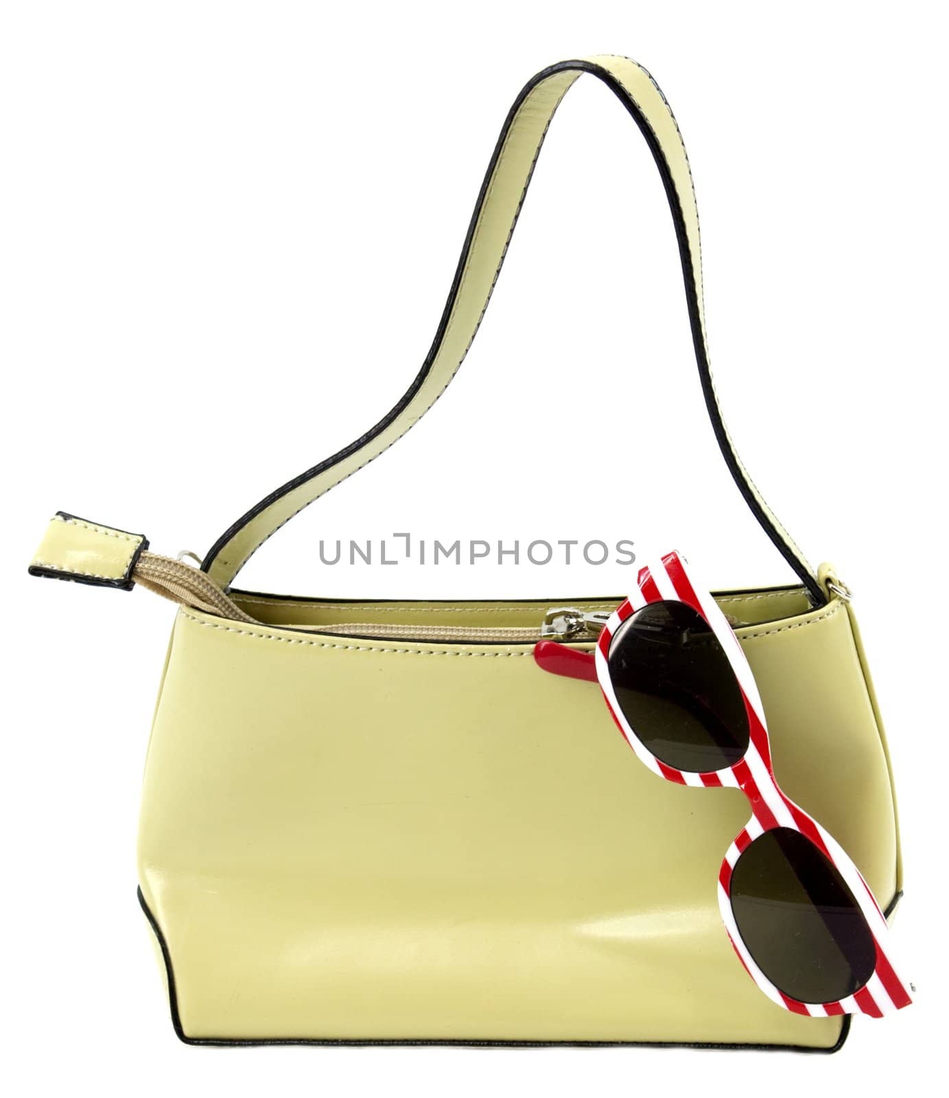 Purse with striped sunglasses on white background