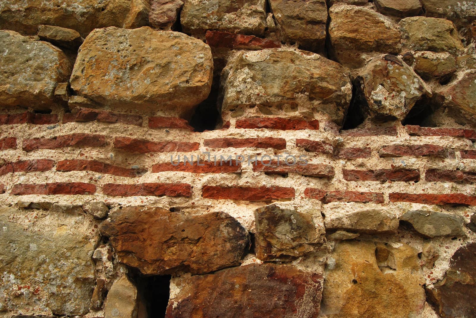 Ancient roman wall, stones, ceramic bricks closeup