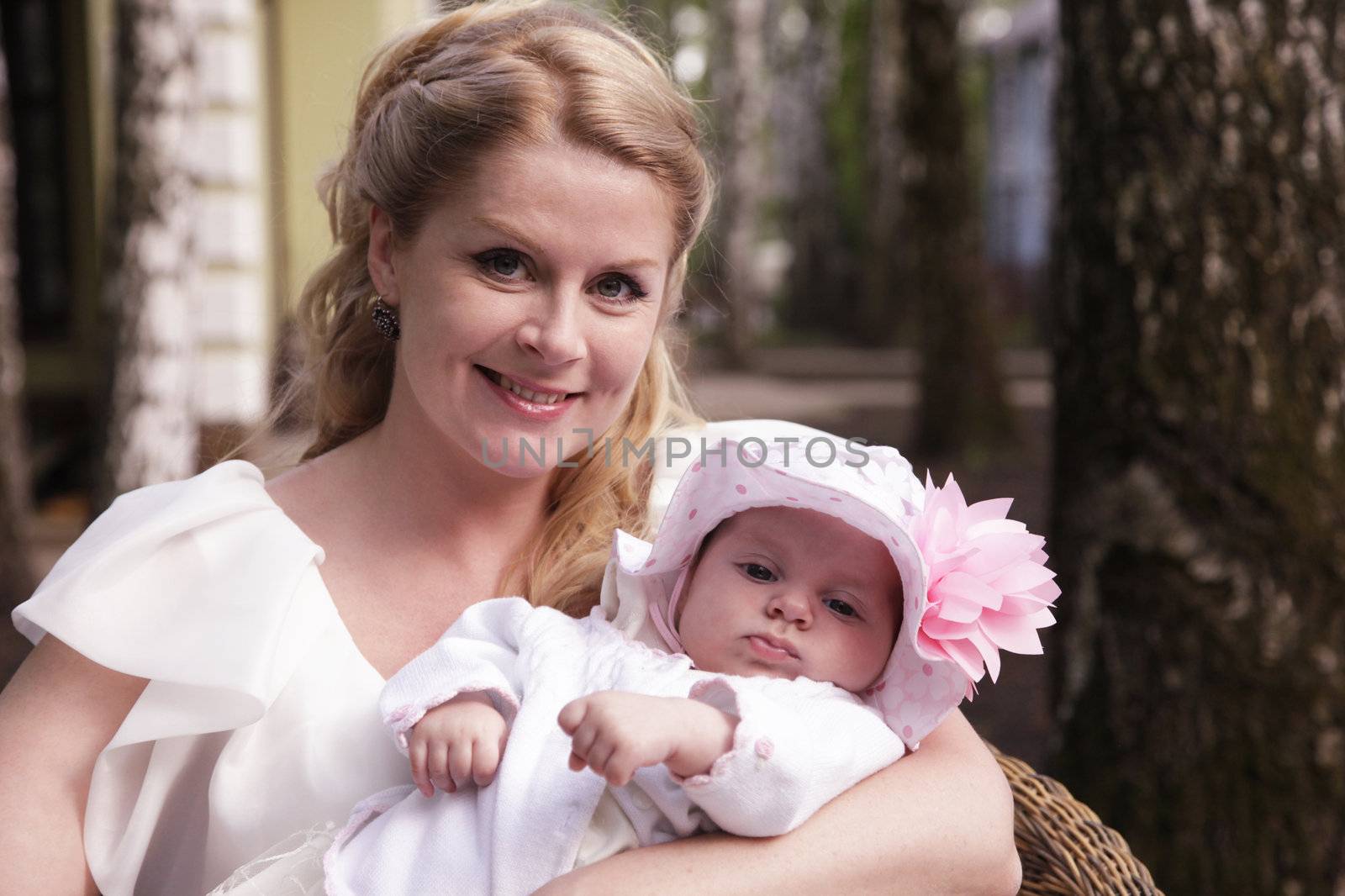 Portrait of beautiful happy smiling mother with baby outdoor, on nature