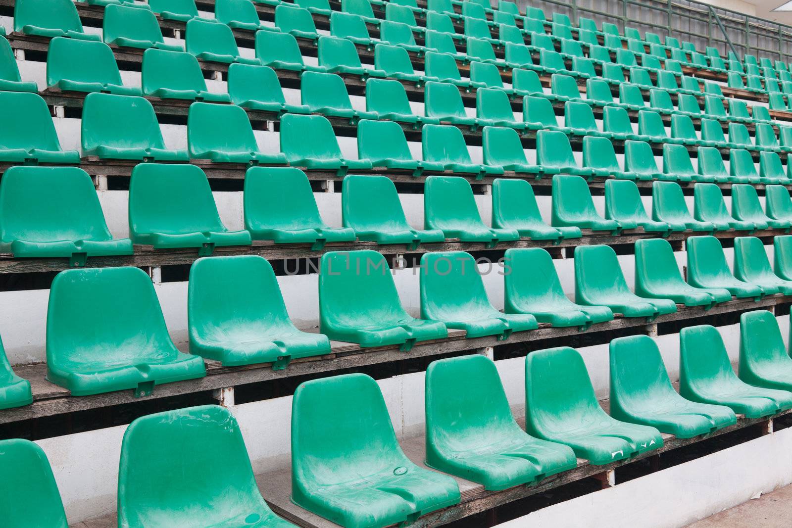 Chairs in stadium by Portokalis