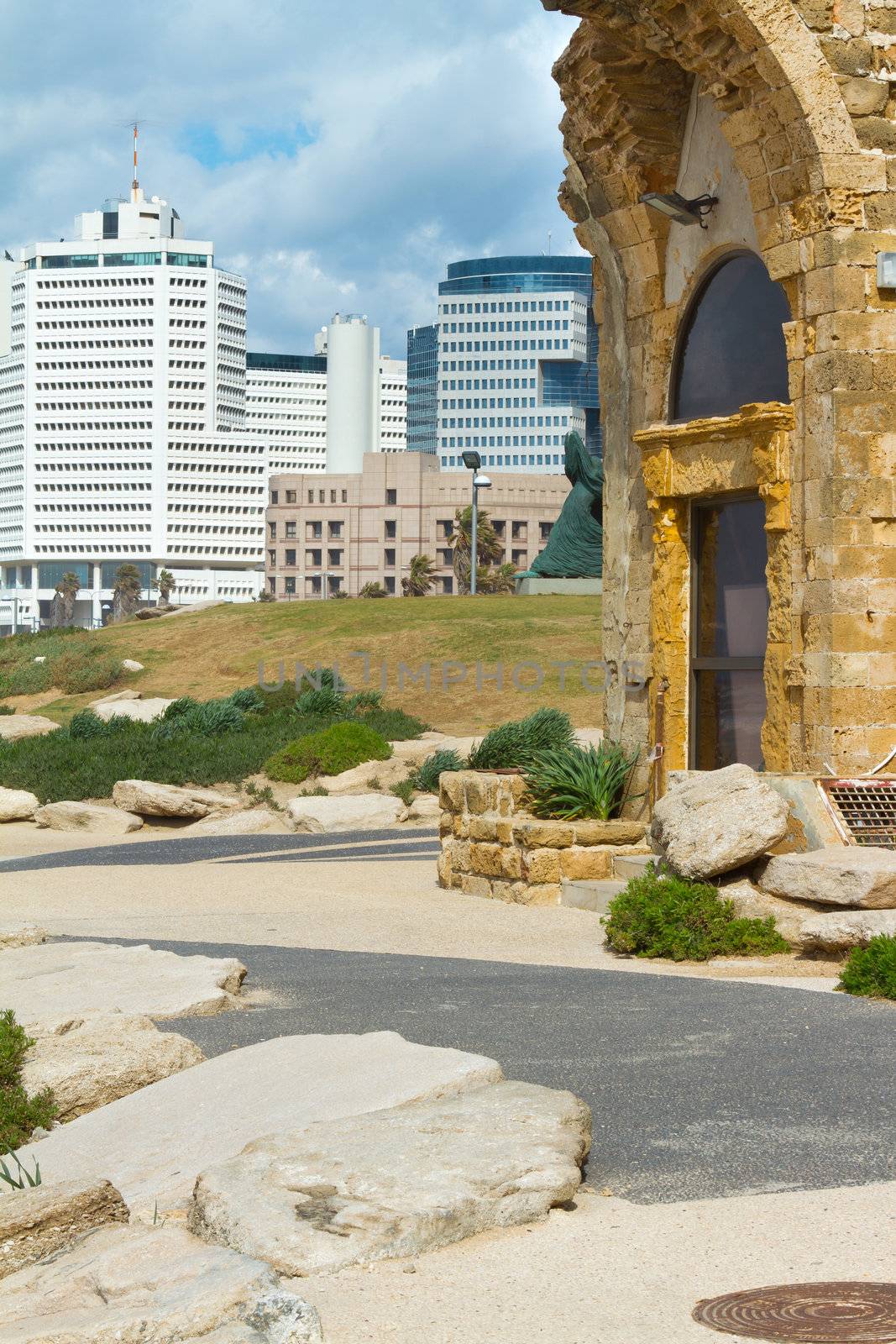 Fragment of an old building on the background of the new skyscrapers