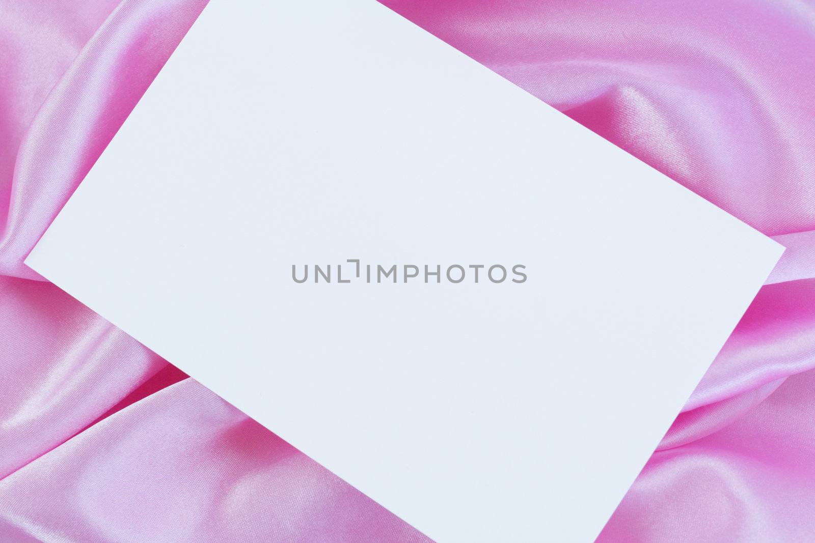 White blank card on pink satin