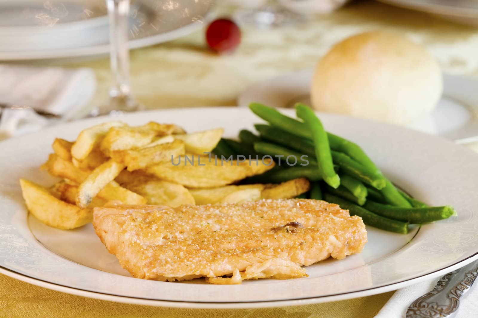 Plate of delicious fried salmon on table by jarenwicklund