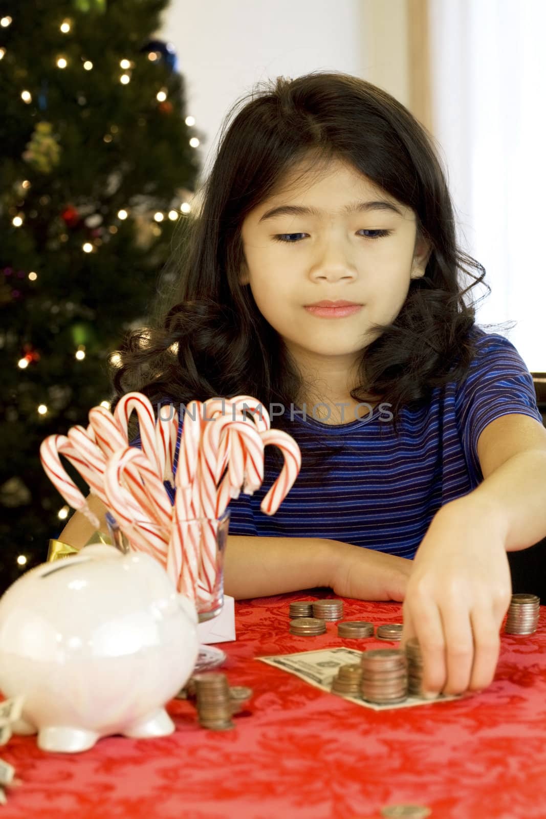Little girl counting money at Christmas