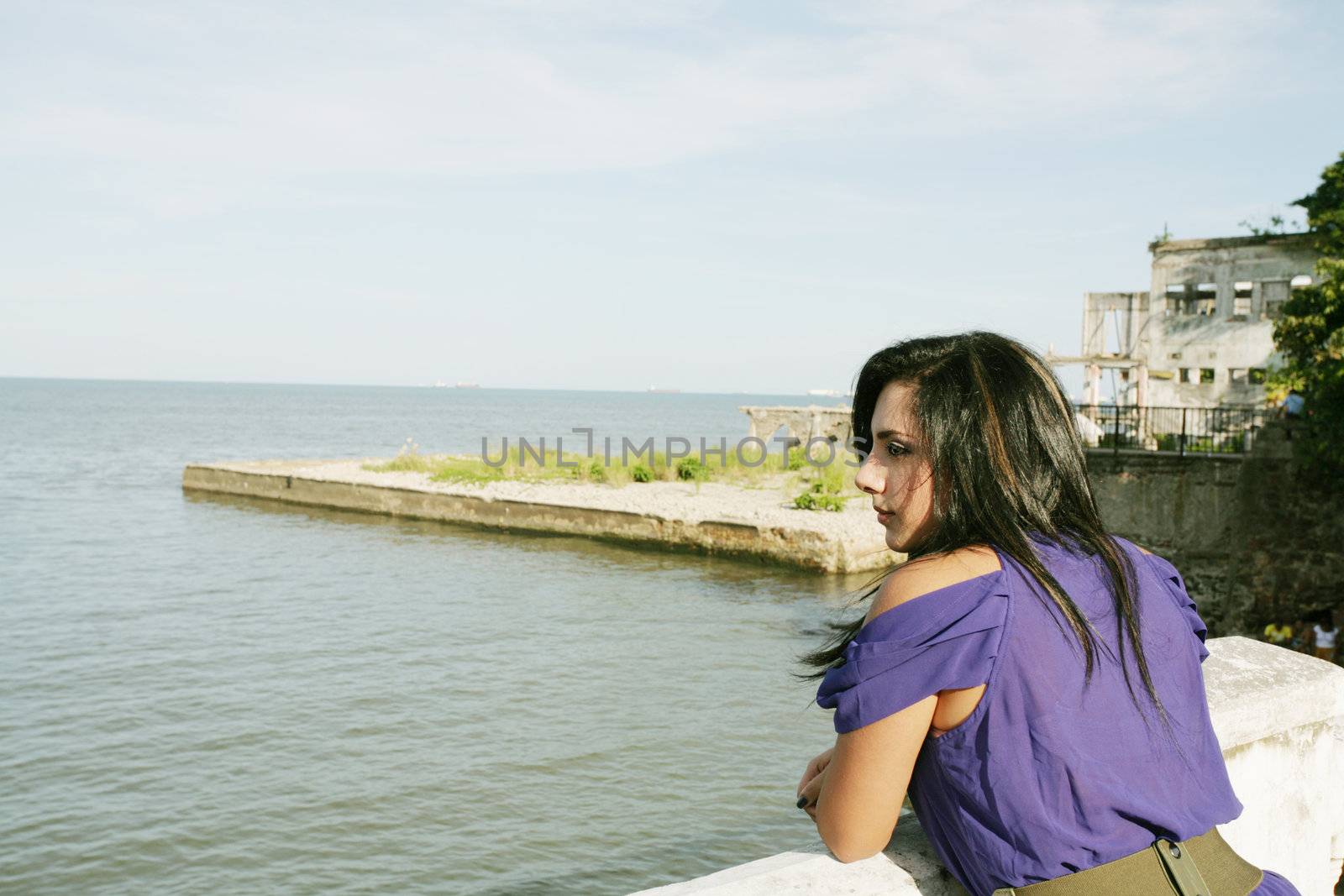 Beautiful caucasian woman looking out over sea