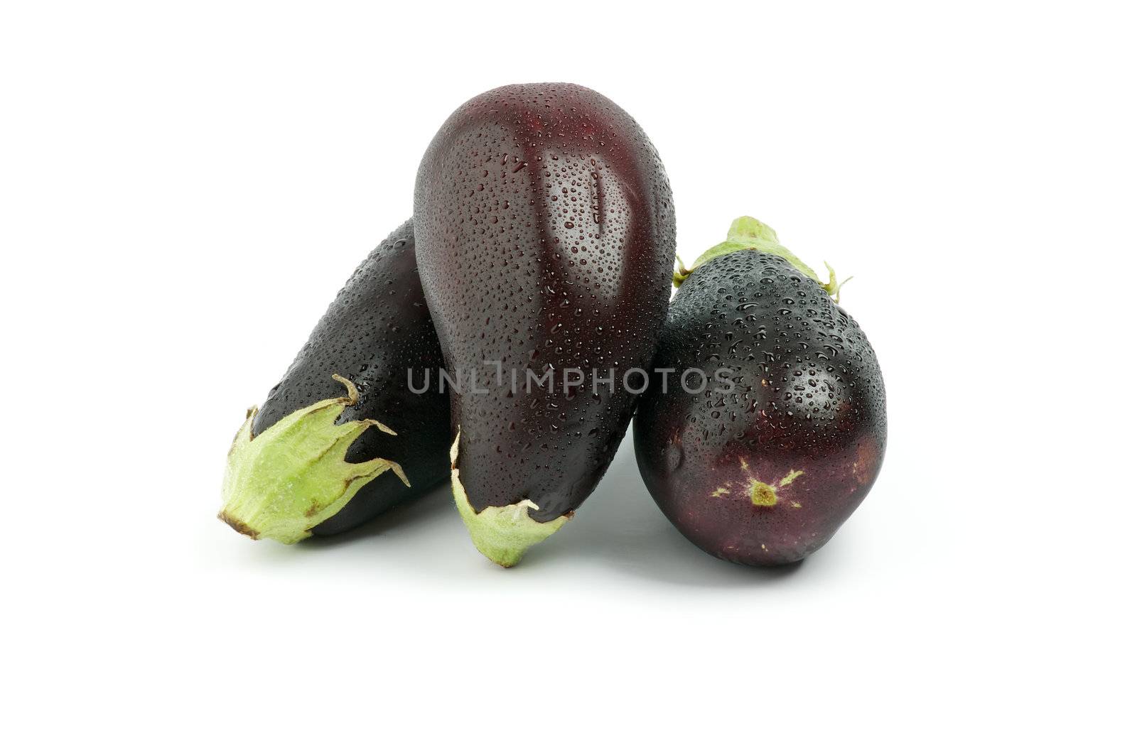 Arrangement of Three Fresh Eggplants with Water Droplets isolated on white background