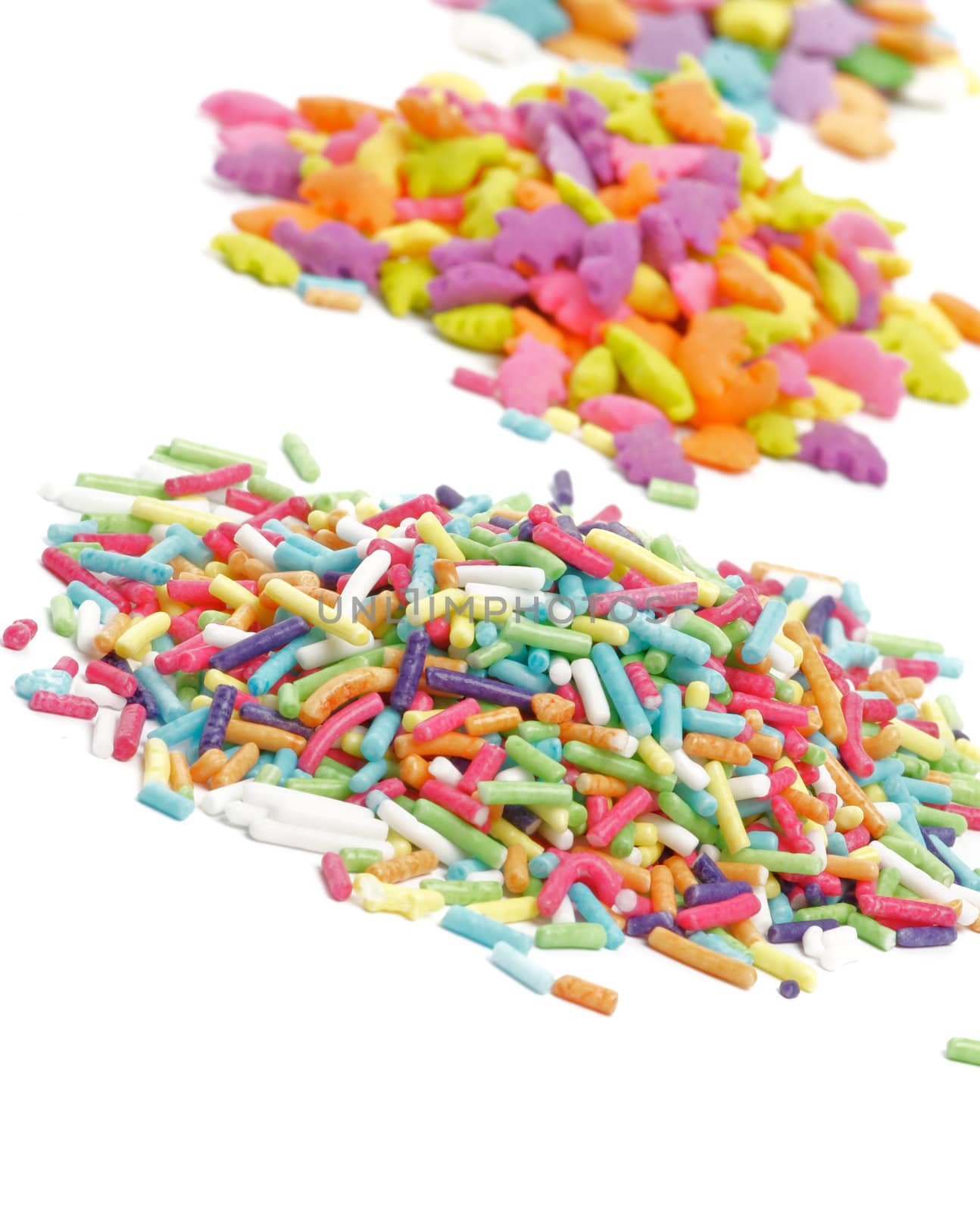 Heaps of Multi Colored Sprinkles "Jimmies" and Stars closeup on white background